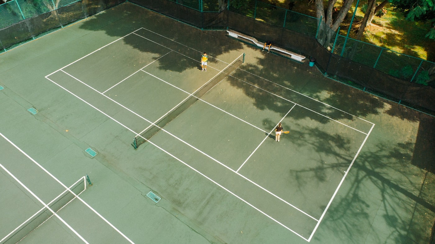Aerial view of tennis coaching session